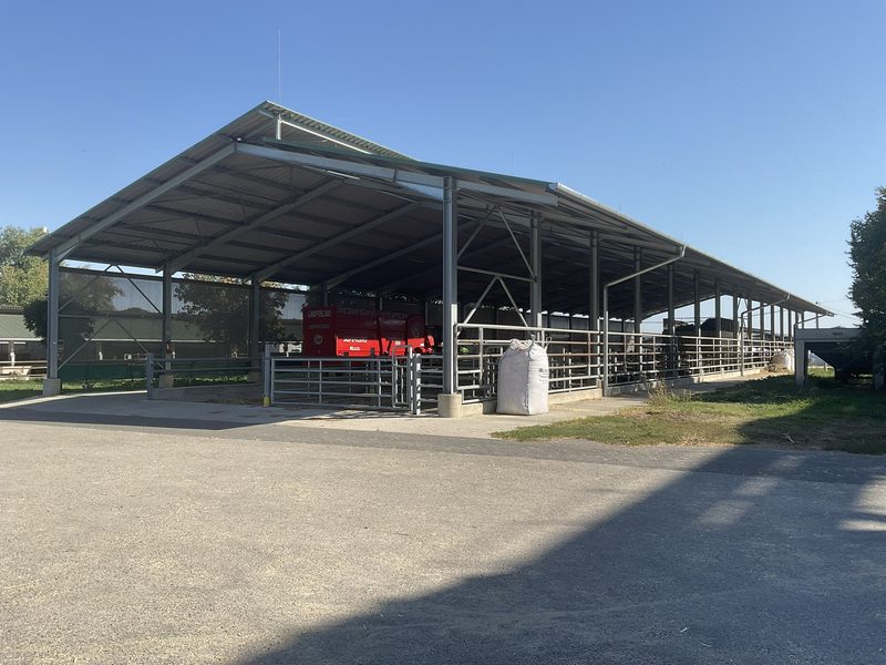 A pitched steel structure, open at the sides for natural ventilation.