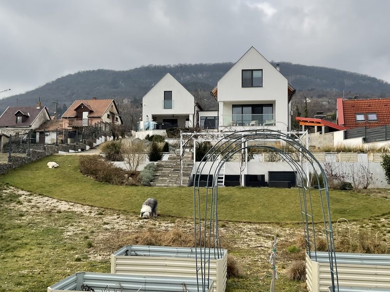 The two pitched-roof wings on the hillside, with the Badacsonytomaj butte behind.
