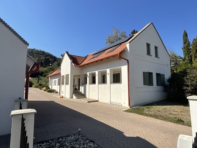 The colonnaded loggia in front of the guest units, with solar panels on the roof.